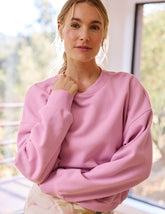 pink crew neck loose-fitting classic length sweatshirt.